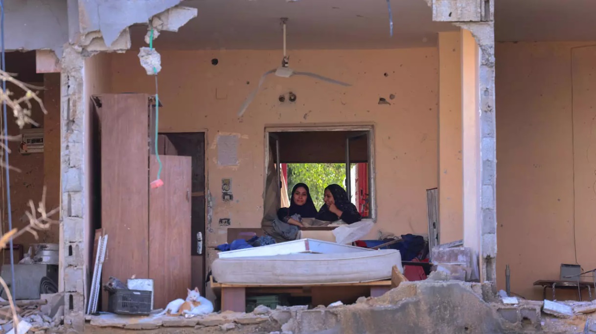 سيدتان فلسطينيتان في منزلهما الذي دمره قصف إسرائيلي في بيت حانون في شمال قطاع غزة في 21 أيار/مايو 2021. © أ ف ب